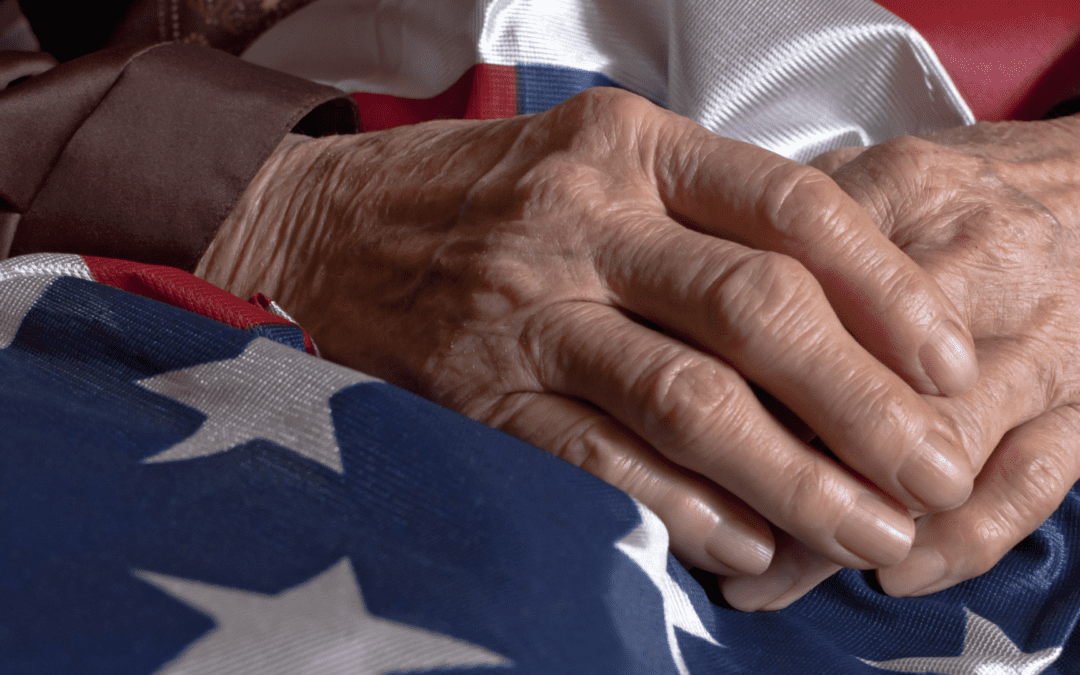 old woman's hands on american flag