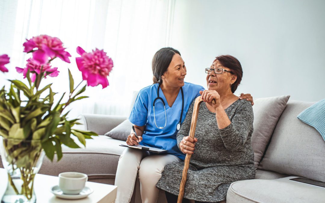 Health visitor and a senior woman during home visit. A nurse or
